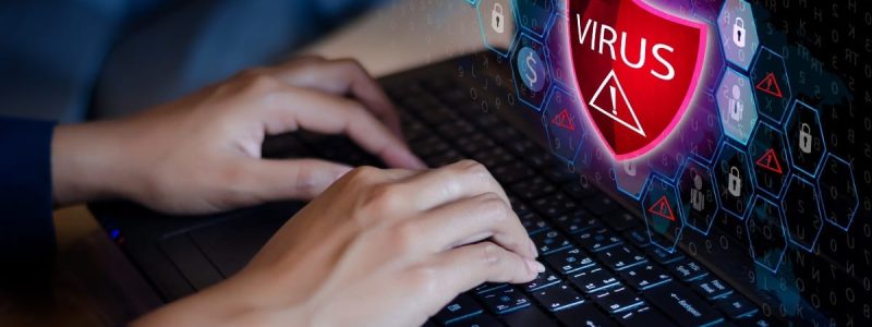 Press enter button on the keyboard computer Protective shield virus red Exclamation Warning Caution Computer in dark with word virus